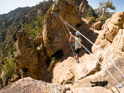 By the end of the 2000s, via ferratas had begun pushing westward, with a handful of routes. Here, a child crosses a ravine on a slackline near Lake Tahoe, California.