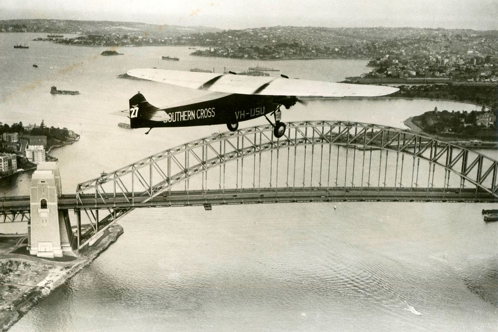 After his celebrated trans-Pacific flight, Charles Kingsford Smith flies the famed Southern Cross over Sydney Harbor.