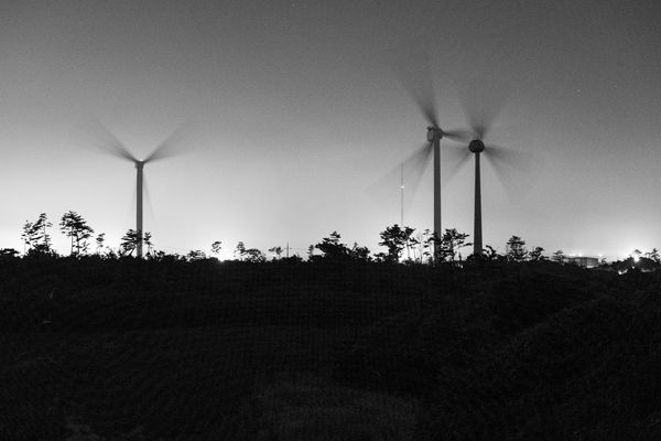 Wind Turbines Spinning at Night thumbnail