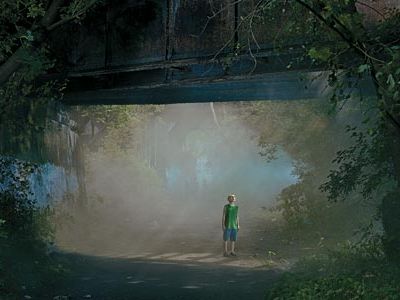 boy under a bridge