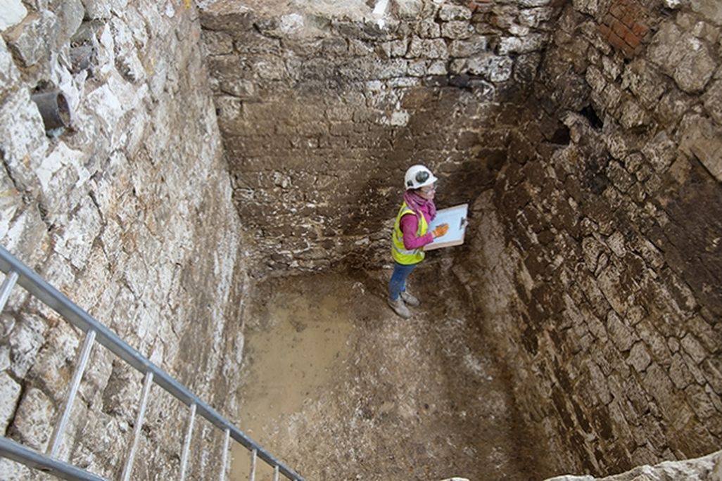 Archaeologists in cesspit