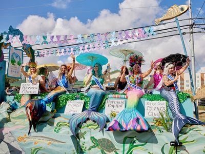 &quot;AquaReinas,&quot; or costumed mermaid messengers with the Mermaid Society of Texas, participate in the 2022 Mermaid Capital of Texas Fest parade in San Marcos, Texas.