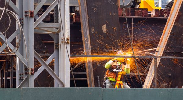 Construction Worker Spraying Sparks Amidst a Downtown Manhattan Building Project thumbnail