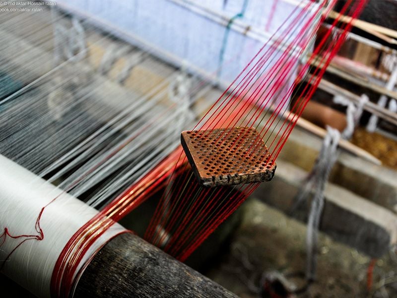 Weaver creating muslin fabric