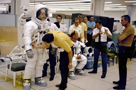 Apollo 11 astronauts Neil Armstrong (L) and Buzz Aldrin prepare for an EVA training session, watched by Deke Slayton (R) in this undated handout photo courtesy of NASA.