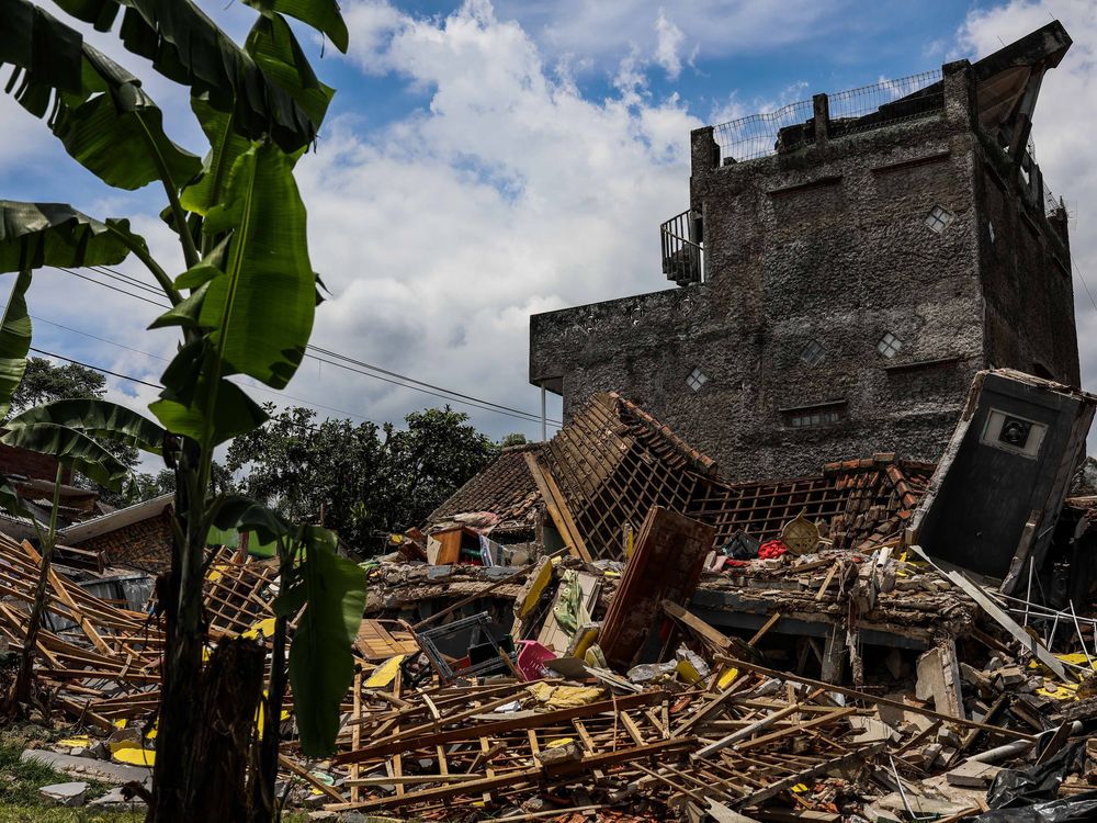 Rubble lies on the ground from a house damaged by the earthquake