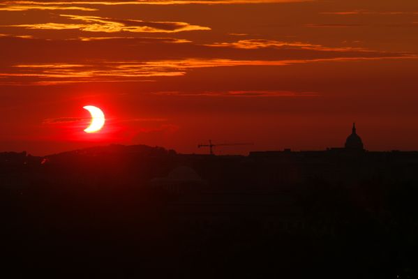 Partial eclipse sunrise over Washington, DC. thumbnail