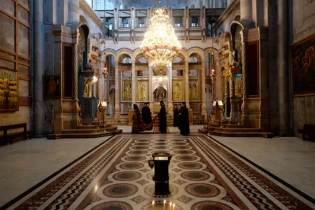 Greek Orthodox priests taking part in a procession inside the Katholikon, or Catholicon Chapel, in the Church of the Holy Sepulcher in Jerusalem.