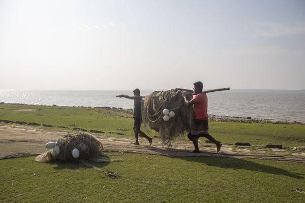 Fisherman carrying net thumbnail