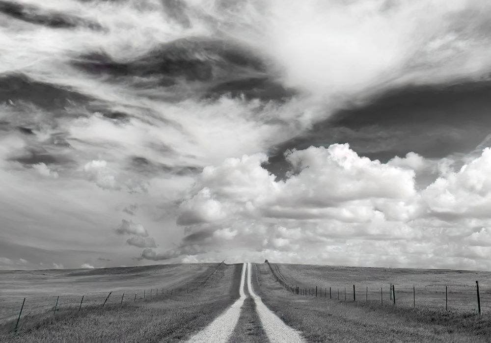 Clouds over a gravel road in central South Dakota. The Midwest and Great Plains are often considered tedious to travel through. Not for me. Instead of looking down from a jet, I choose to drive, looking up.