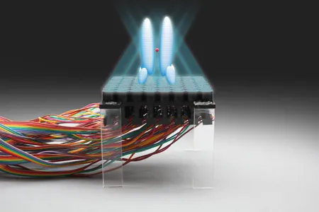 An artist's rendering shows an acoustic hologram trapping a particle over a levitation device.