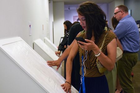 A visitor to the Andy Warhol Museum experiences a Warhol print of a Coca-Cola bottle with the help of an audio app and a tactile 3D reproduction. 