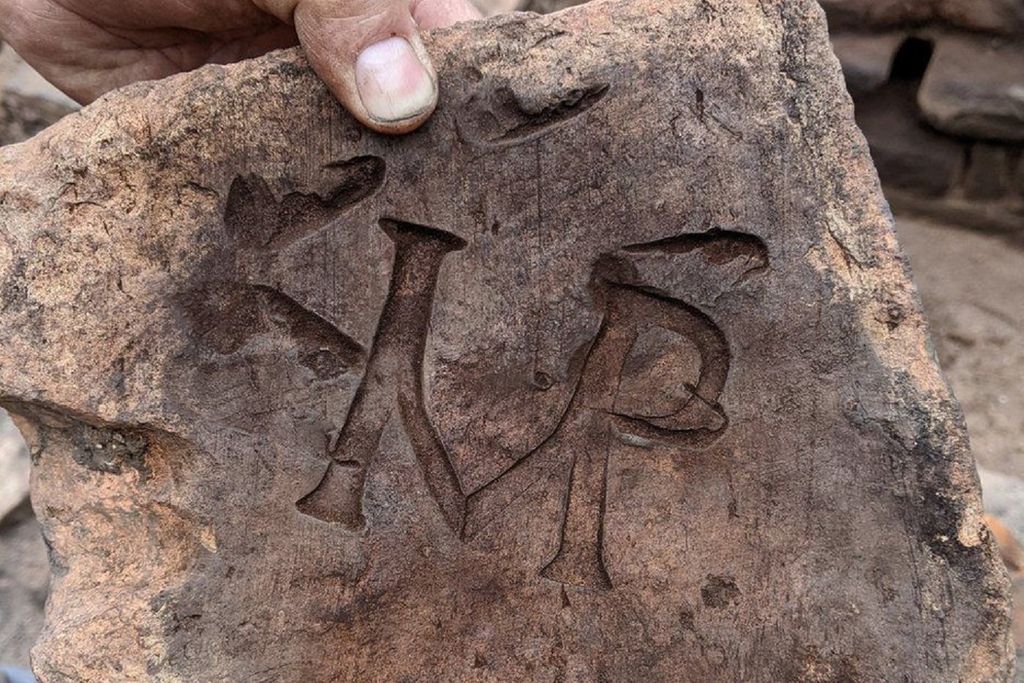 Tile stamped with the letters 'IMP'