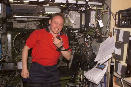 NASA astronaut Mike Fincke uses the amateur radio on board the International Space Station to talk with crew at the Palmer Research Station in Antarctica in 2004.