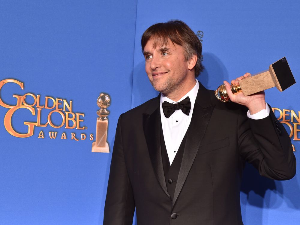 Richard Linklater holding a Golden Globe Award