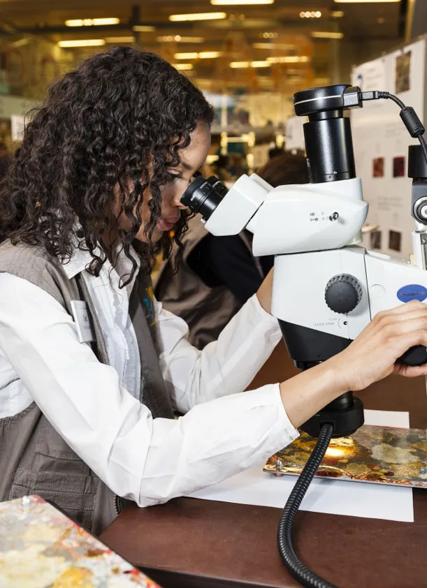 Authentic tools of the trade, like a scientist’s microscopes, are on hand.