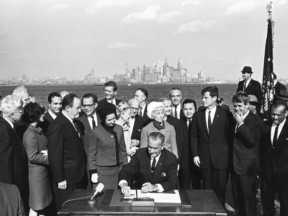 President Lyndon B. Johnson signs the Immigration Bill of 1965 on Liberty Island in New York Harbor.
