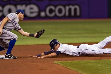 Texas Rangers second baseman Ian Kinsler tags out Tampa Bay Rays' Sam Fuld on a stolen base attempt.  