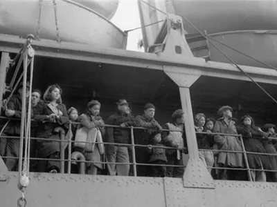 Aleutian people stand on the deck of a ship forcibly evacuating them to southeastern Alaska.