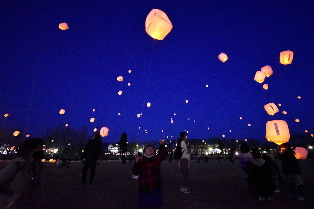 Local residents release lanterns for earthquake and tsunami victims in Koriyama, Fukushima prefecture on March 11, 2021