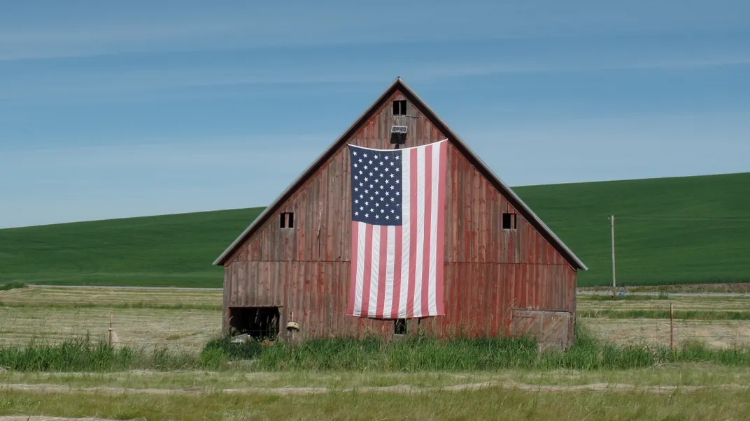 8 - A large American flag drapes a modest barn in the Palouse area of Washington.