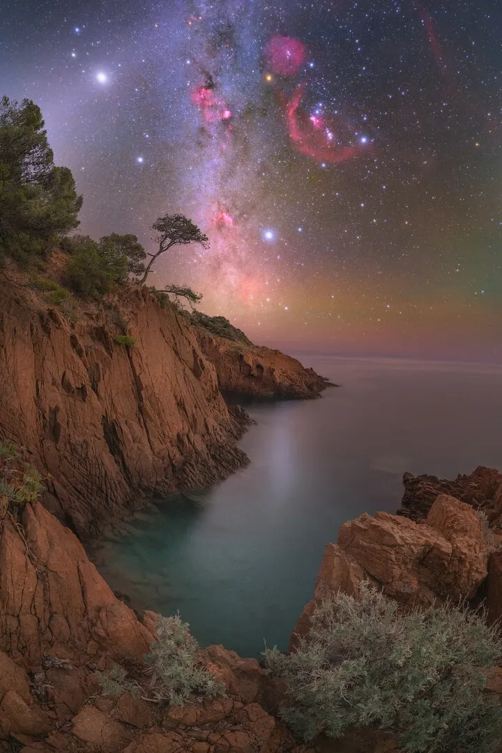 The milky way vertical over a coastline