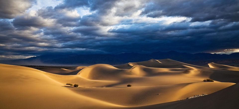  Rolling sand dunes under stormy skies in Death Valley 