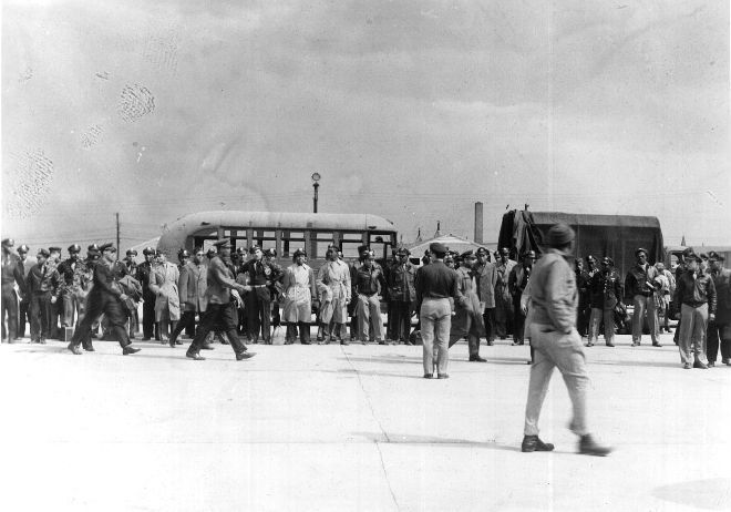 The 101 African American officers arrested at Freeman Field about to be transported to Goodman Field, Kentucky. This image was likely taken with a hidden camera by Master Sergeant Harold J. Beaulieu, Sr. Other photographs of the event taken by another African American enlisted man were destroyed by a white officer on the spot.