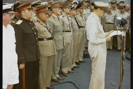 General Douglas MacArthur making remarks at the surrender ceremony aboard the USS Missouri. Behind him are representatives of the major Allied powers. U.S. National Archives, Army Signal Corps Collection, USA C-2716.