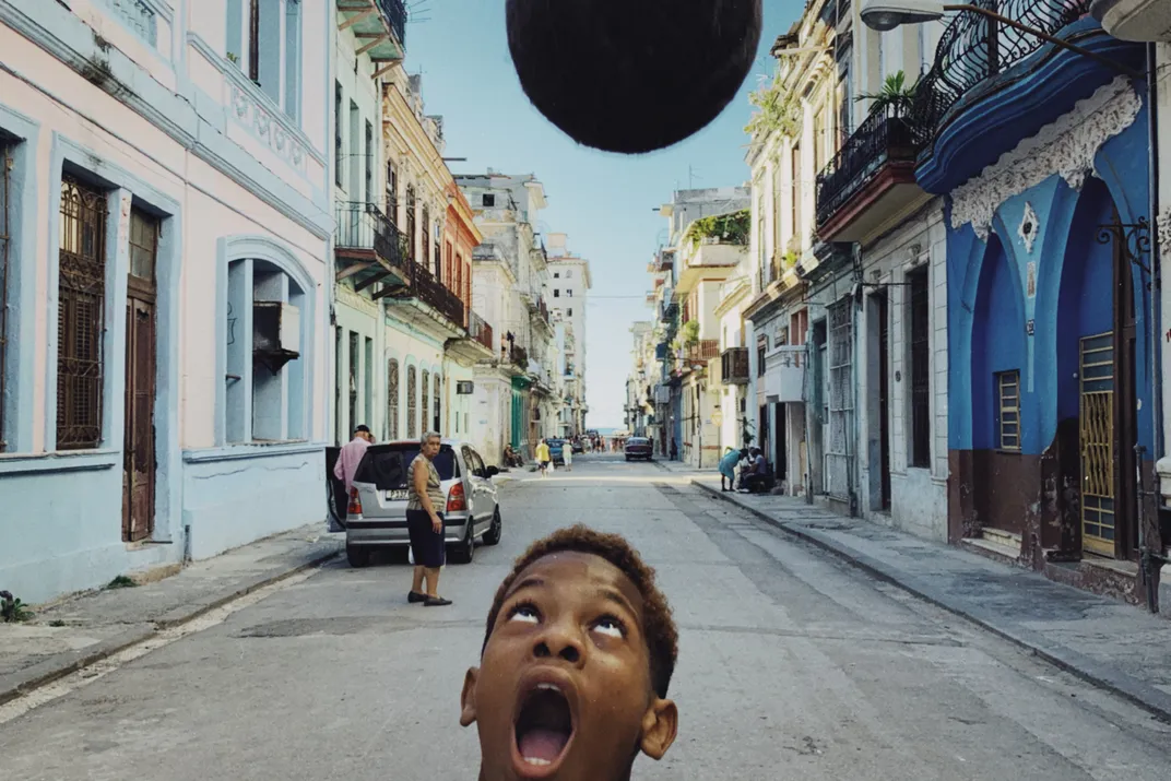 a child plays soccer in the streets