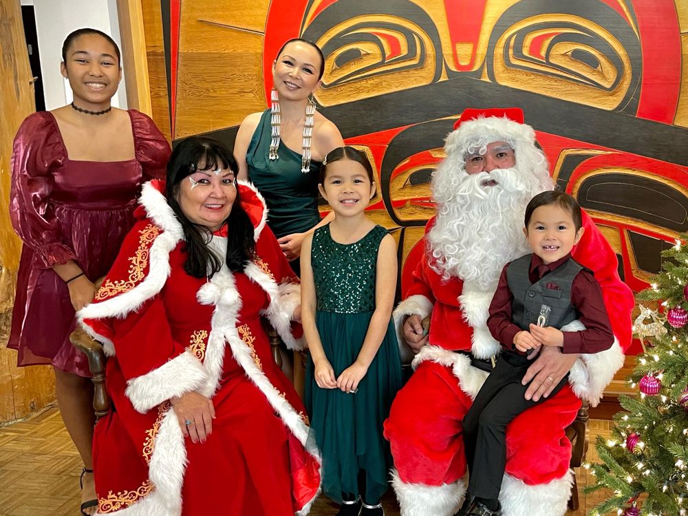 Indigenous family surrounding Santa Claus