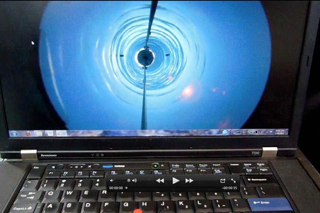 A camera passes down through the borehole.
