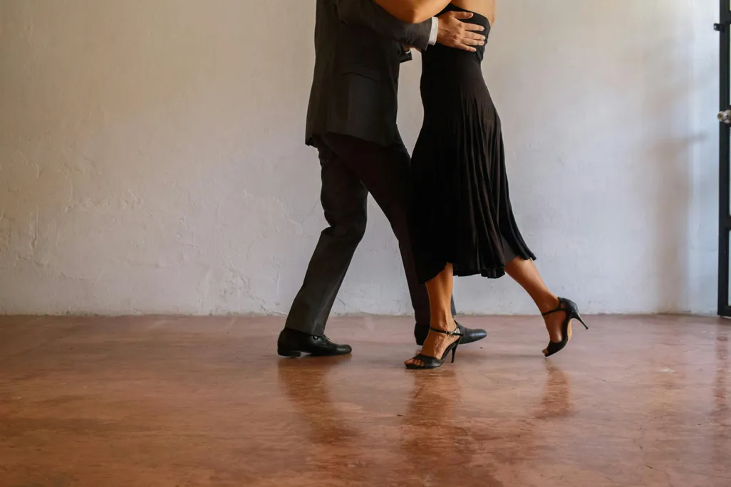 legs of people dancing the tango