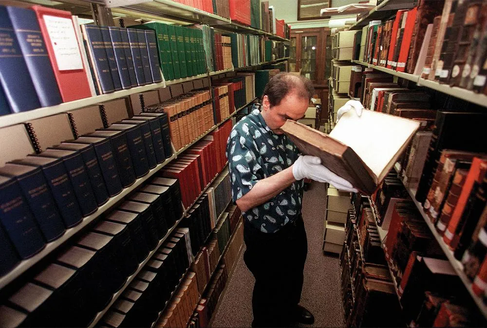 Greg Priore examines a book