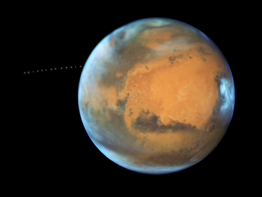 A photo of Mars with a time lapse of its moon Phobos orbiting it