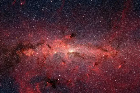 The sugar was detected near the center of our Milky Way galaxy, which shines brightly with stars in this artificially colored image.