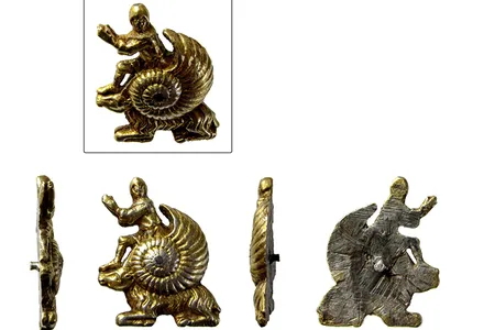 The intricately crafted ornament, which depicts a knight emerging out of a snail shell perched atop of a goat, measures less than an inch long.