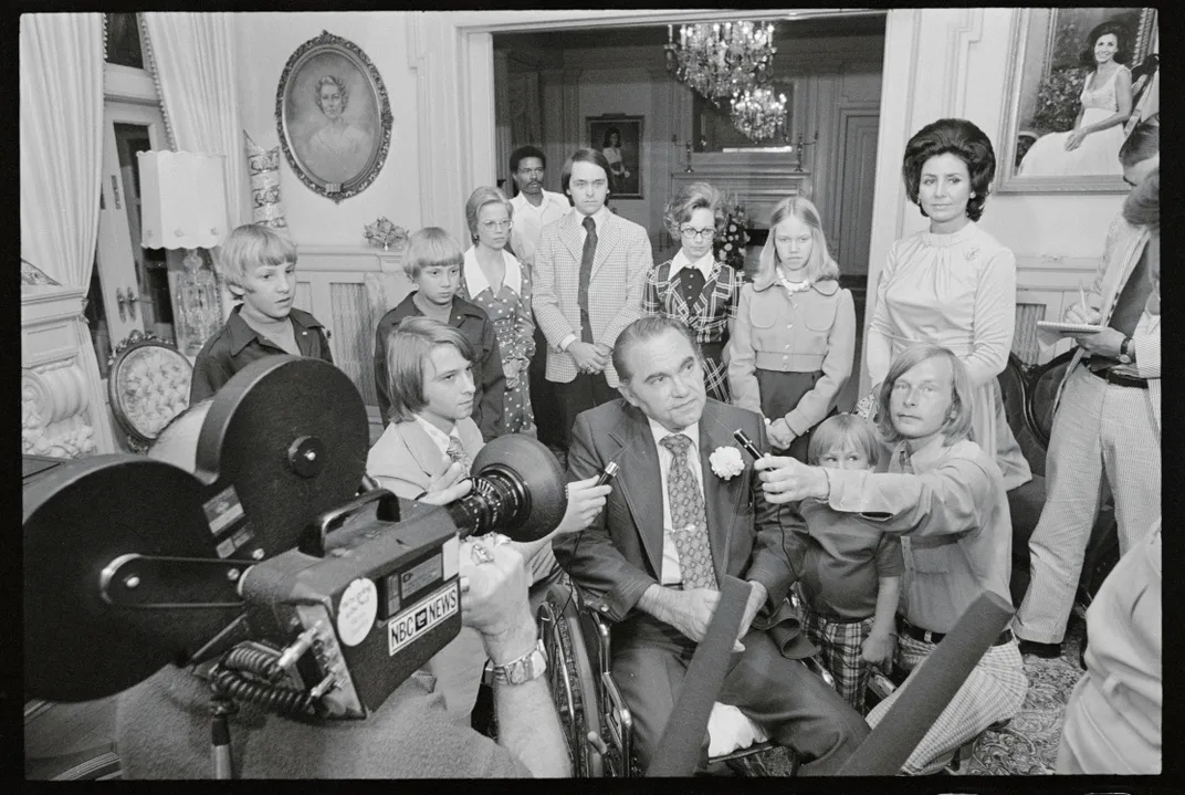 Wallace chats with reporters after learning he'd won a landslide victory in his bid for nomination to a historic third term as governor in 1974.