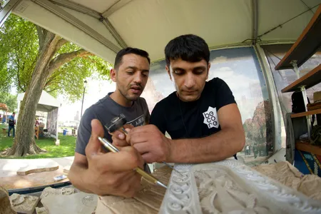 This past October, Ruben Ghazarayan (above left with his brother Karen at the 2018 Smithsonian Folklife Festival) fought on the frontlines of the Nagorno-Karabakh conflict, his brother is selling their Armenian cross-stones to support their families during the conflict. 