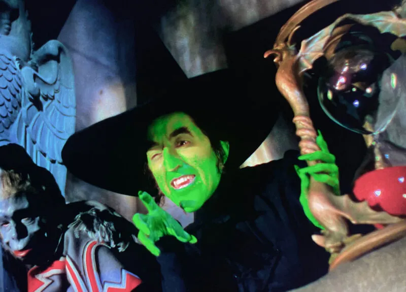The Wicked Witch of the West, played by Margaret Hamilton, holding the hourglass