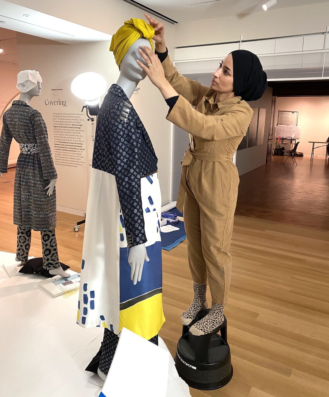 Saba Ali styles a mannequin in the Contemporary Muslim Fashions exhibition