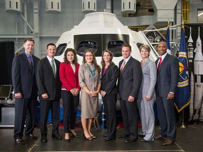 NASA’s 2013 astronaut candidates, nicknamed the “Eight Balls,” pose in front of a mockup of the Orion capsule at the Johnson Space Center in Houston, last August. From left: Tyler Hague, Andrew Morgan, Jessica Meir, Christina Hammock, Nicole Mann, Josh Cassada, Anne McClain, and Victor Glover. 