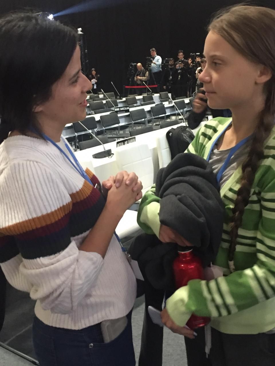 two young women excitedly greet each other