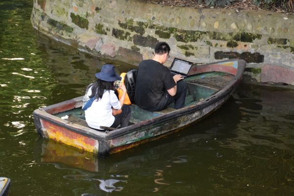 A Couple on Boat for a Ride on Their Electronics thumbnail