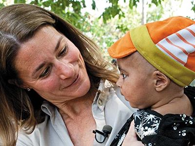 Melinda Gates, with caregivers in Rampur Bhuligadha, India, says infant deaths can be halved by 2025.