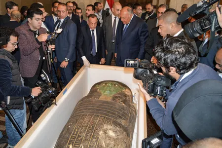 Egyptian officials with the ancient sarcophagus on January 2, 2023