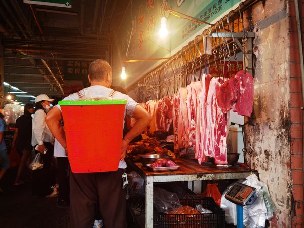 the man in front of the butcher's shop thumbnail