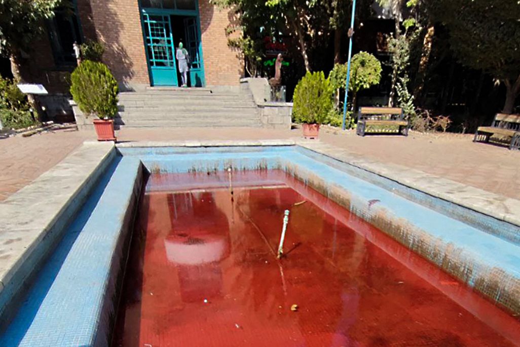 A fountain with its water dyed red outside the Artists' Forum at Honarmandan Park in the Iranian capital Tehran