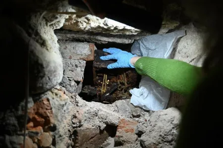Researchers found the pieces covered in newspaper and tucked beneath a staircase in the crypt.