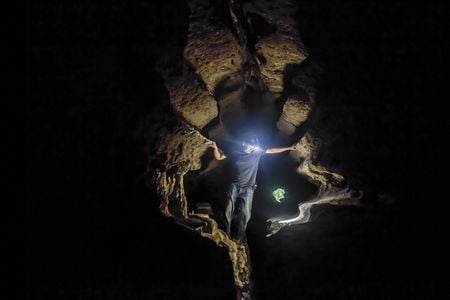 Dr. Maxime Aubert, archeologist and geochemist, uses his headlamp to examine the cave art at Leang Lompoa in Maros, Indonesia.